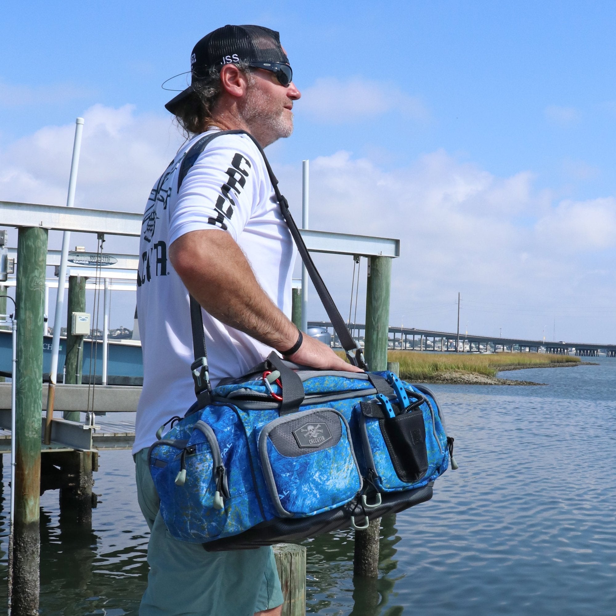 Fisherman with Calcutta Squall 3700 Tackle Bag with Bait Binder